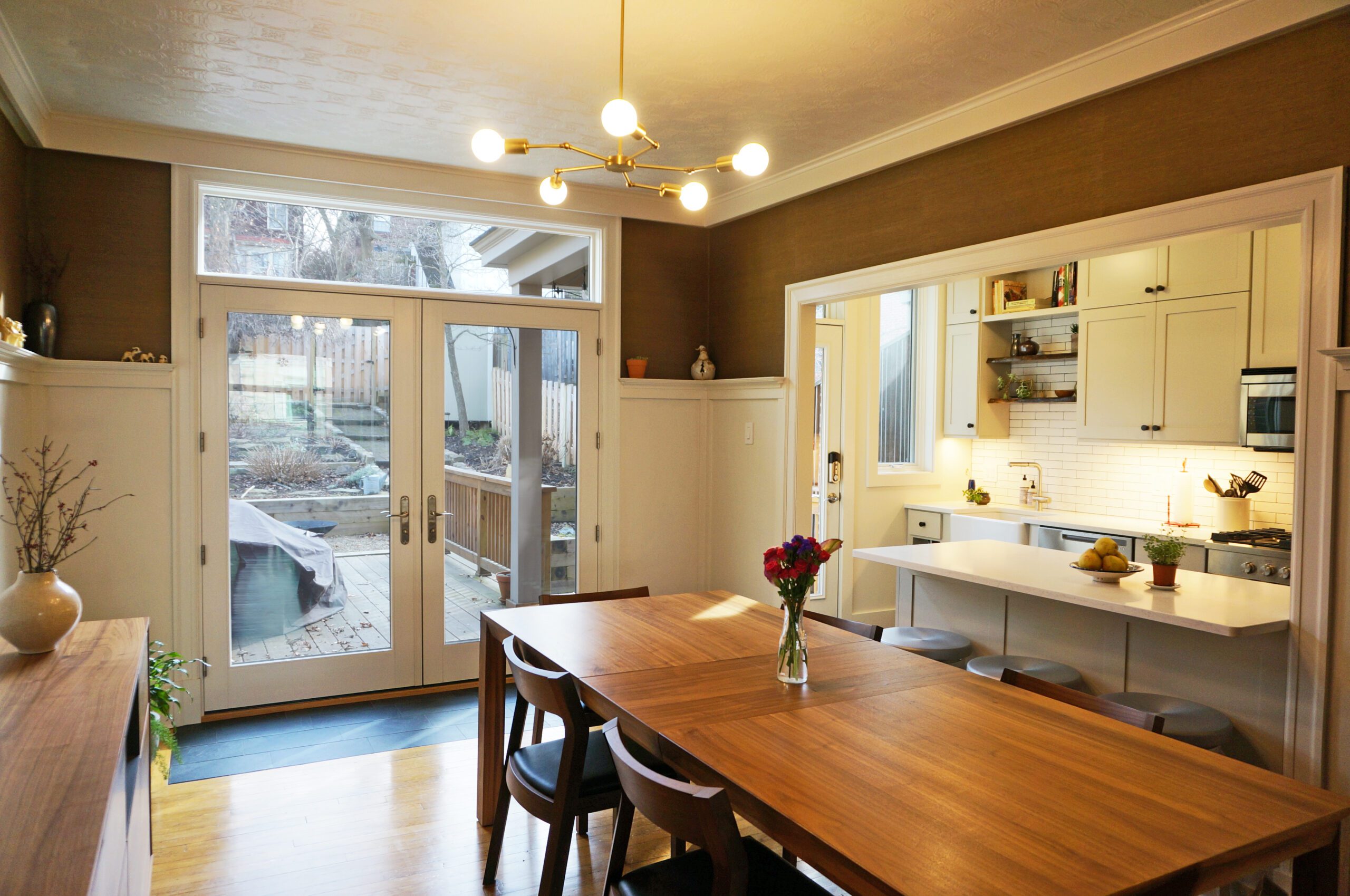 Modern kitchen with dining area leading to an outdoor space.